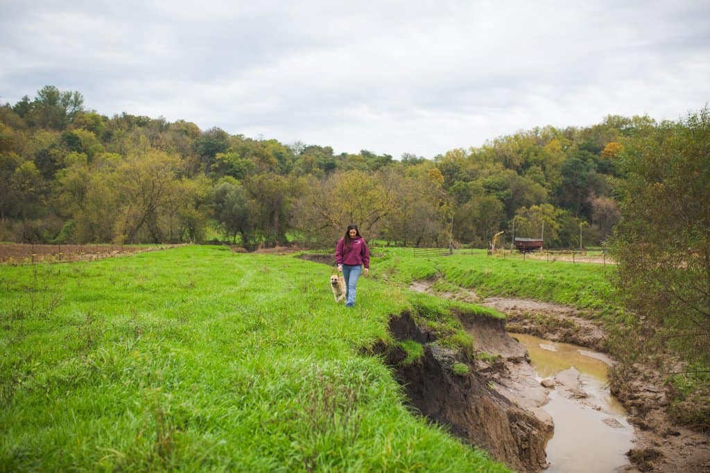 RanchHer and FarmHer Tammy Wiedenbeck walks along farm erosion from recent floods