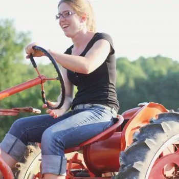 kate edwards of wild woods farm drives her tractor