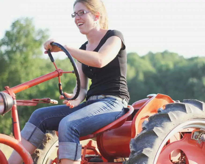 kate edwards of wild woods farm drives her tractor