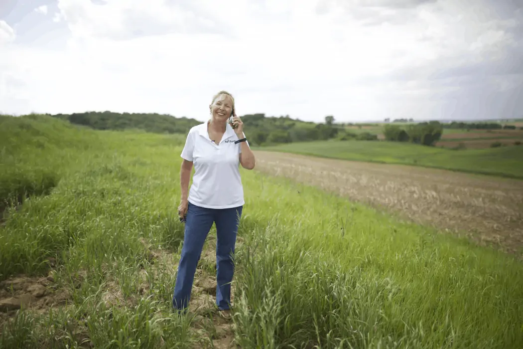 Sara Wyant, creator of Agri-Pulse and media journalist standing on her century farm.