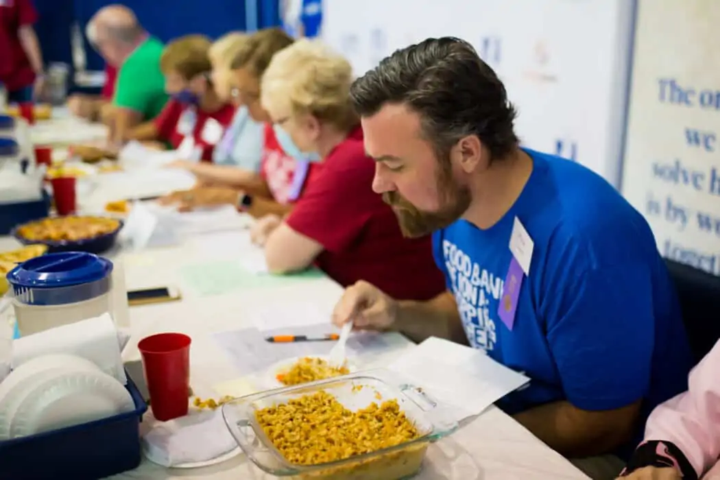 Judges tasting casseroles at the Food Bank of Iowa Chopped- Hot Dish Edition contest at the Iowa State Fair. 