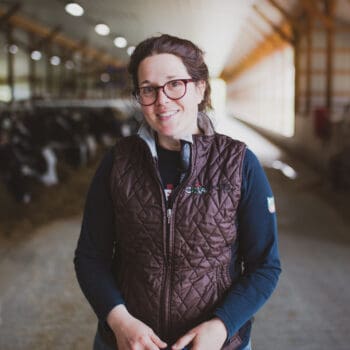 Amanda Freund standing in her family's dairy barn.