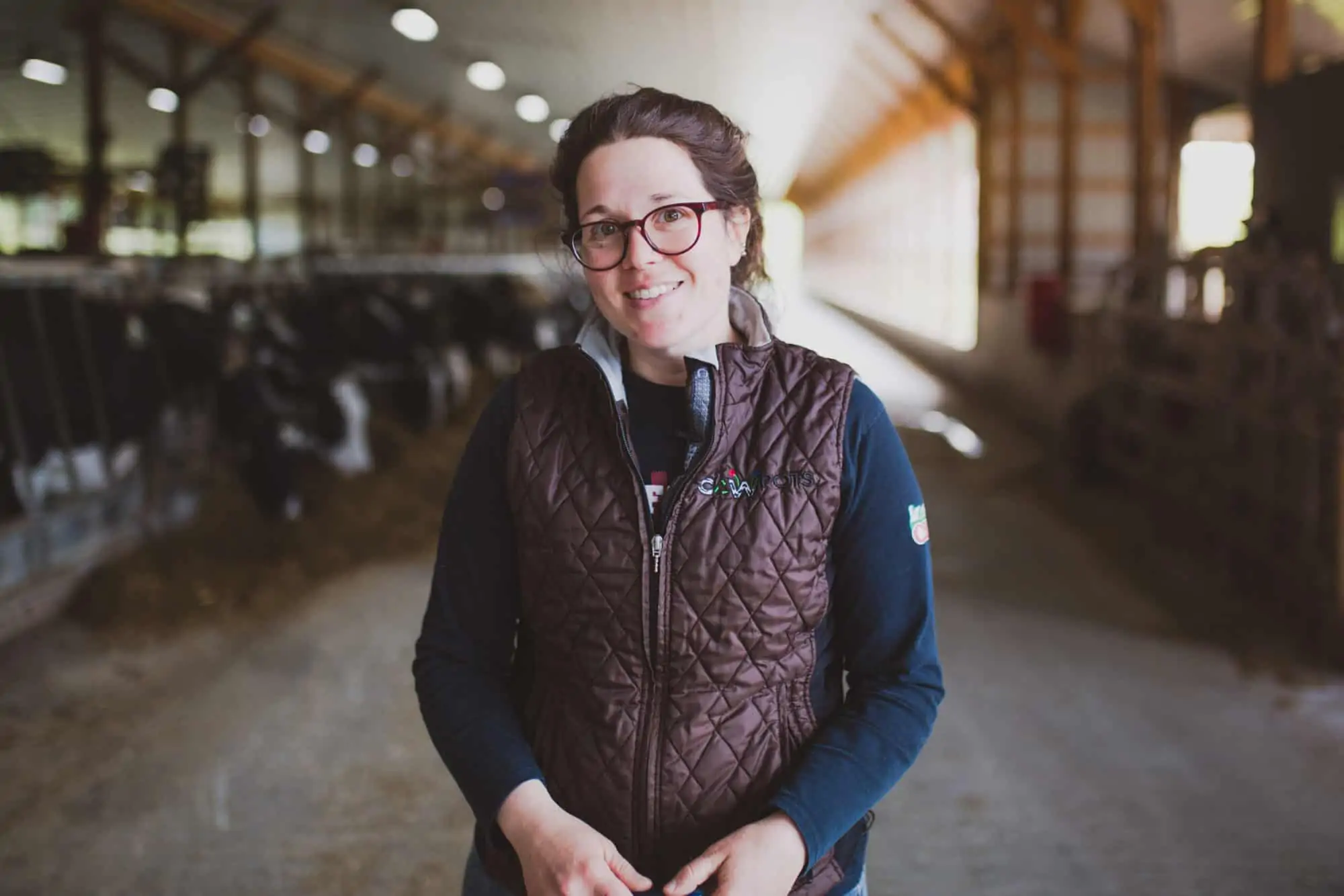 Amanda Freund standing in her family's dairy barn.