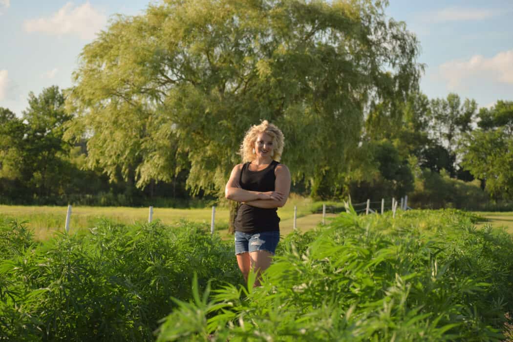 Peggy Coffeen standing in her hemp field that she uses to produce her CBD products. 
