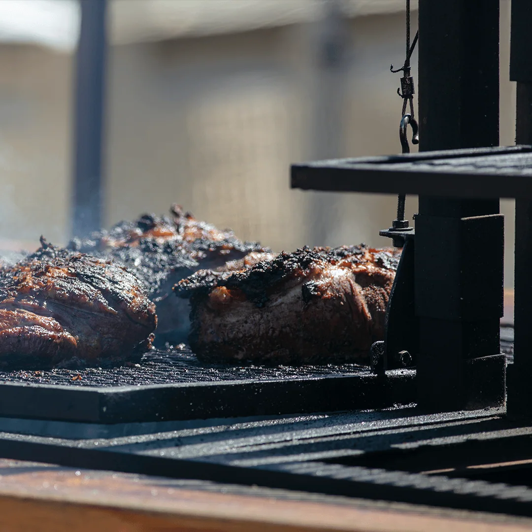 Tri-Tip Beef Roasts Being Cooked at an Outdoor Festival Charred with Smoke Wafting from the Grill
By Gary Peplow