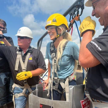 FarmHer Host Kirbe Schnoor volunteers as the victim in a grain bin safety demonstration.